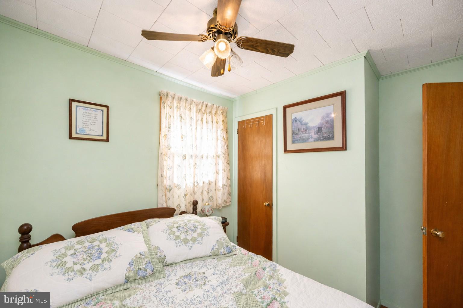 682 Marsh Hill Road McHenry, MD 21541 - Photo 24 of 40 a bedroom with a bed and a painting on the wall