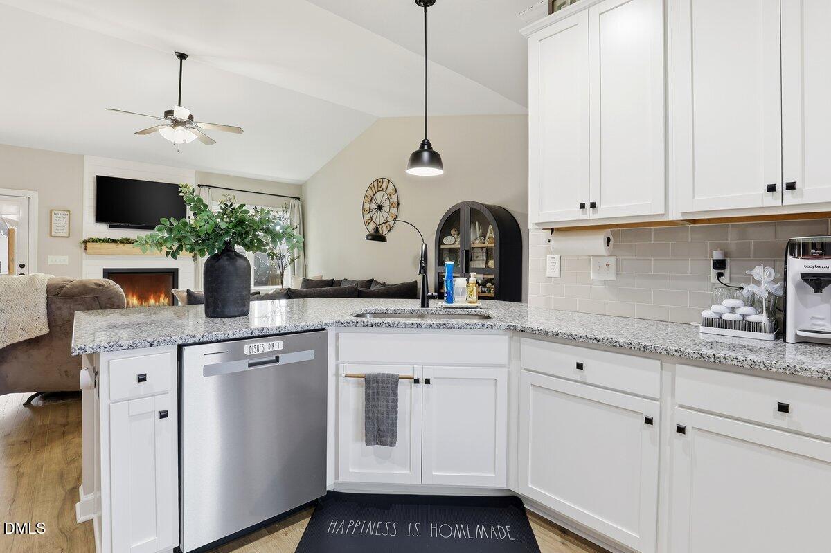 110 Oak Street Pine Level, NC 27568 - Photo 13 of 30 a kitchen with white cabinets and sink