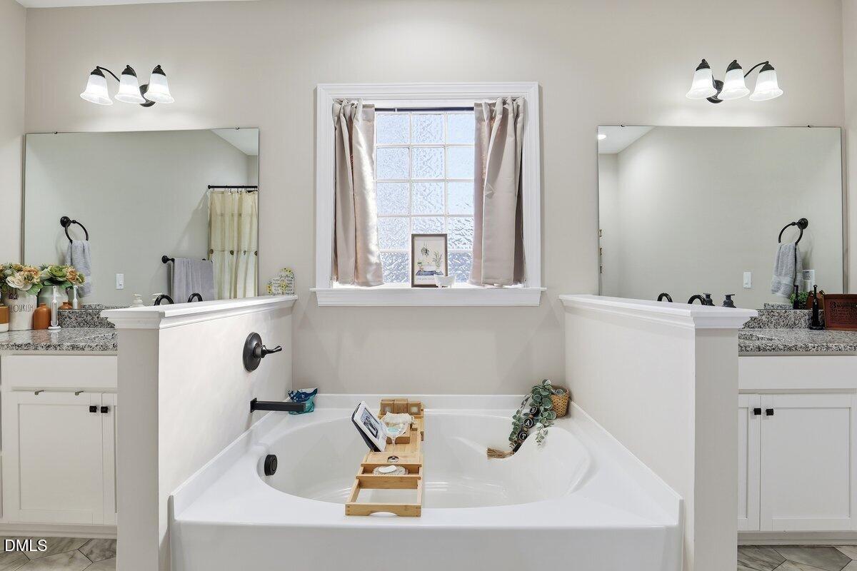 110 Oak Street Pine Level, NC 27568 - Photo 20 of 30 a bathroom with a tub sink and mirror