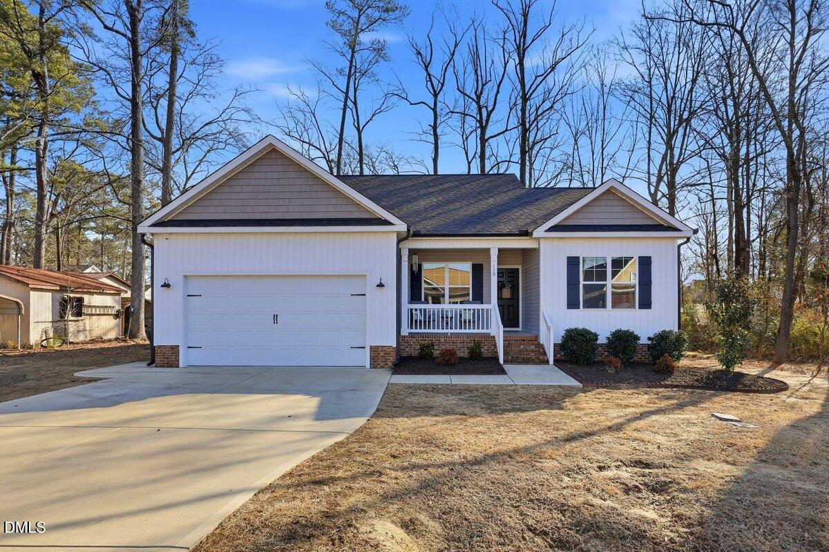 110 Oak Street Pine Level, NC 27568 - Photo 2 of 30 a front view of a house with a yard