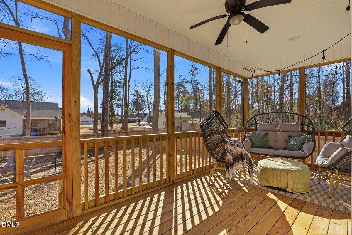 110 Oak Street Pine Level, NC 27568 - Photo 26 of 30 a view of living room with furniture and floor to ceiling windows
