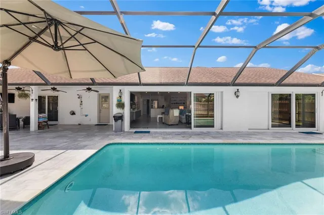 a view of a backyard with swimming pool