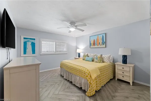a bedroom with a large bed and a chandelier