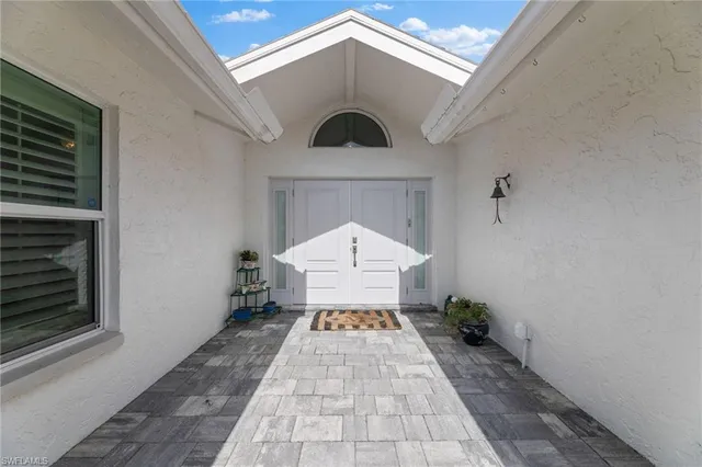 a view of a dining room with furniture and a window
