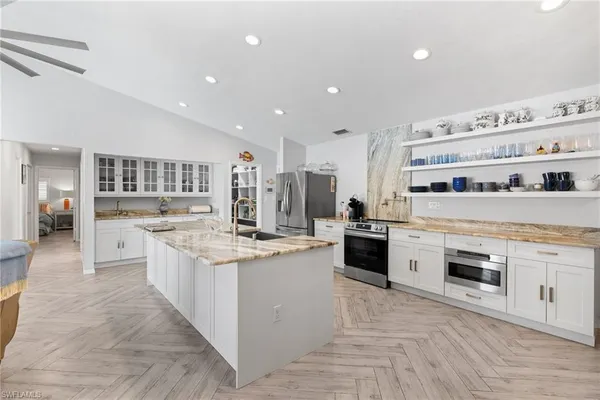 a kitchen that has a sink and a stove in it