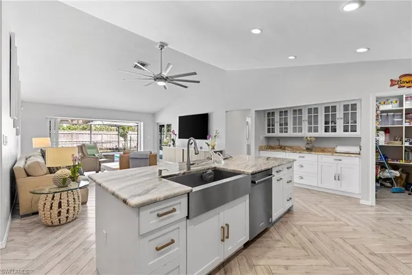 a kitchen with stainless steel appliances granite countertop a refrigerator and a stove top oven