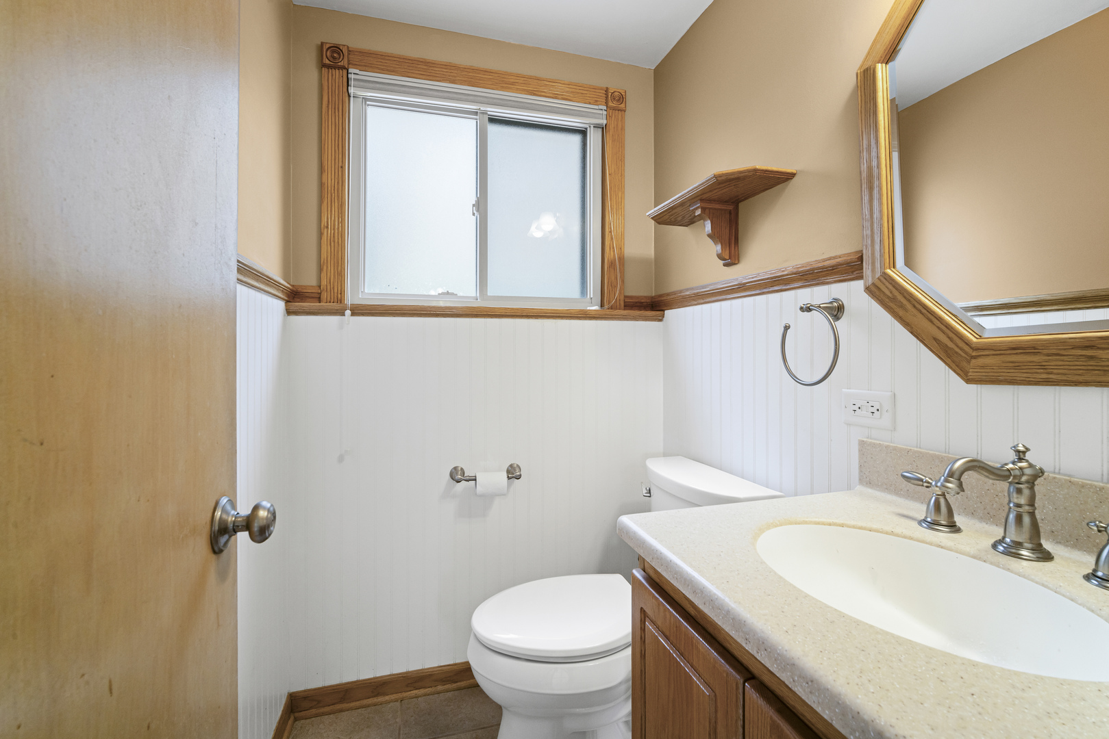 421 North Elm Street Itasca, IL 60143 - Photo 15 of 21 a bathroom with a granite countertop toilet sink and mirror