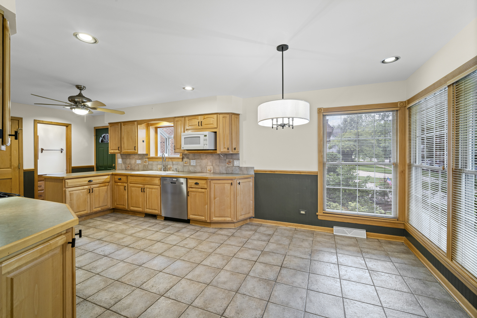 421 North Elm Street Itasca, IL 60143 - Photo 6 of 21 a large kitchen with granite countertop a stove a sink a window and dining table