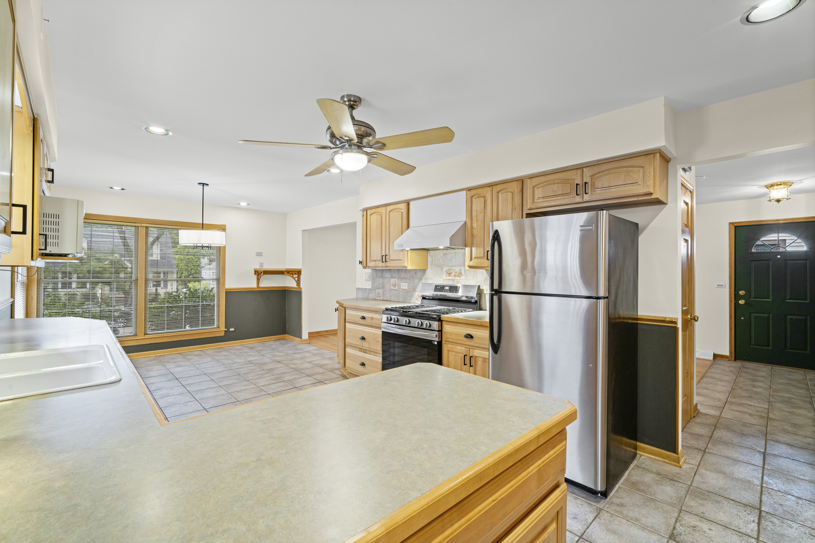421 North Elm Street Itasca, IL 60143 - Photo 9 of 21 a kitchen with a refrigerator a stove top oven and a sink