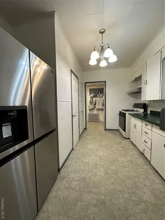 a large kitchen with cabinets and stainless steel appliances