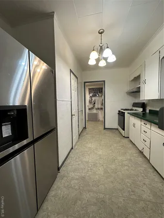 a large kitchen with cabinets and stainless steel appliances
