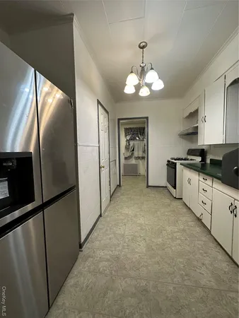 a large kitchen with cabinets and stainless steel appliances