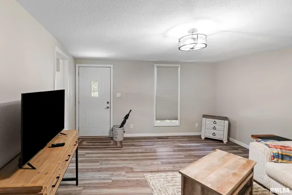a view of a dining room with furniture and a book shelf