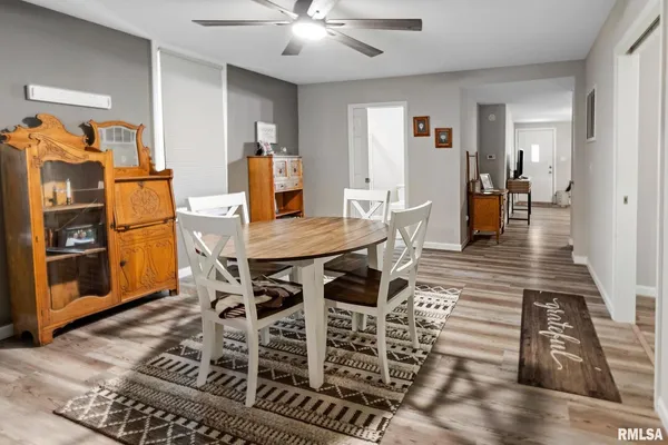 a view of a dining room with furniture and wooden floor