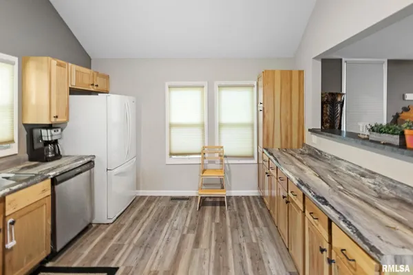 a utility room with sink dryer and washer