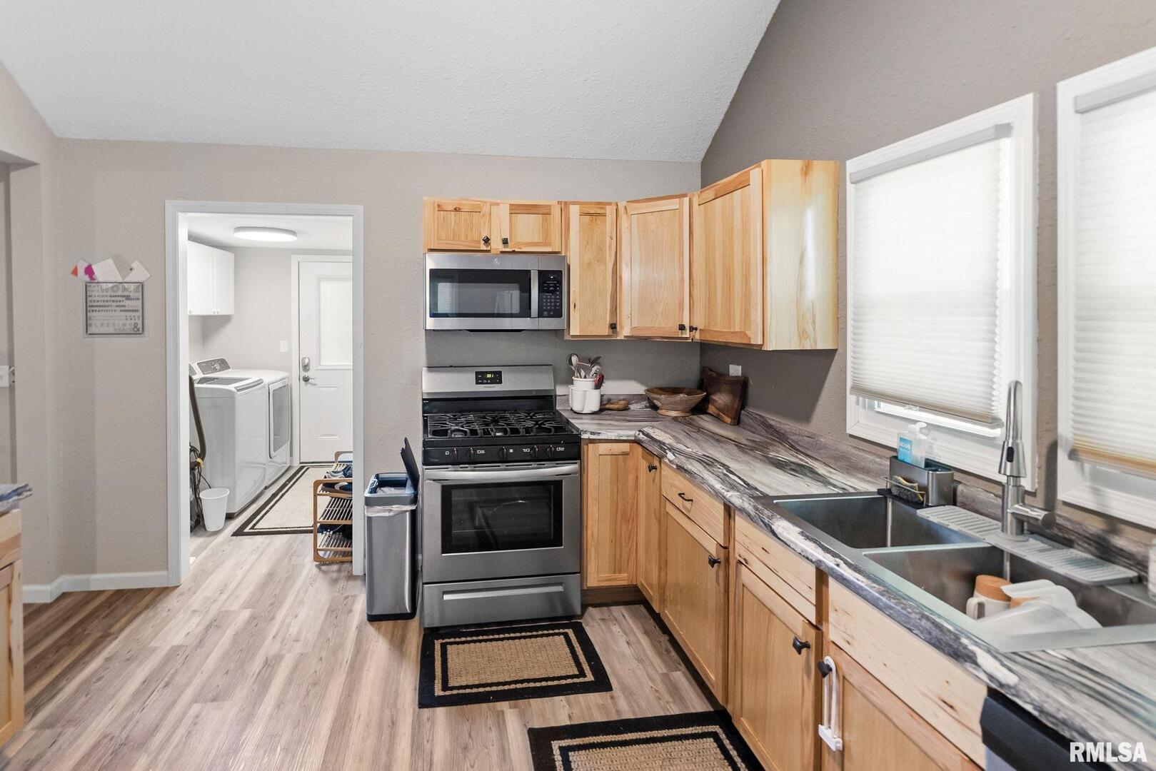 416 South Maple Street Salem, IL 62881 - Photo 21 of 31 a kitchen with stainless steel appliances a stove sink and cabinets