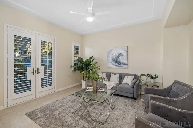 a living room with furniture and a potted plant