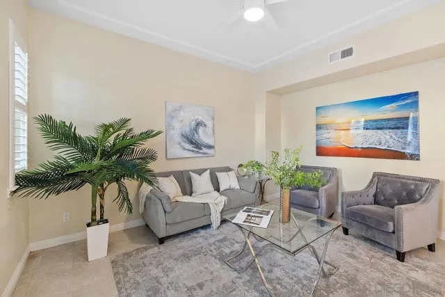a living room with furniture and a potted plant