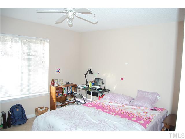 1500 Graduate Lane, Unit 104 Raleigh, NC 27606 - Photo 12 of 15 a bedroom with a bed and a dresser