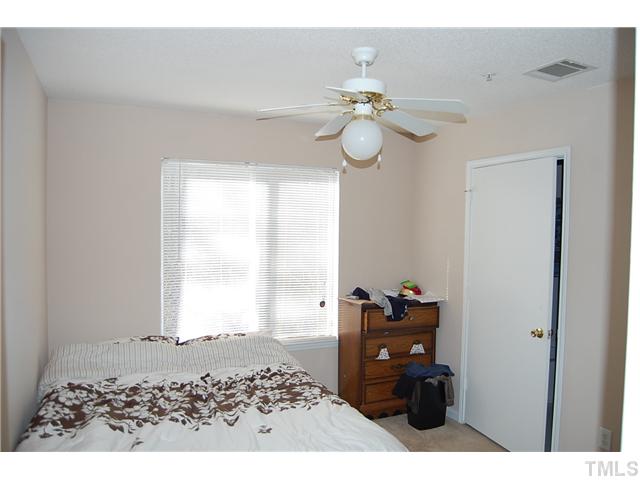 1500 Graduate Lane, Unit 104 Raleigh, NC 27606 - Photo 13 of 15 a bedroom with a bed and window