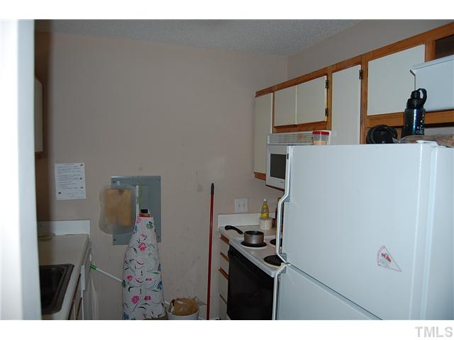 1500 Graduate Lane, Unit 104 Raleigh, NC 27606 - Photo 15 of 15 a kitchen with a refrigerator and a stove top oven