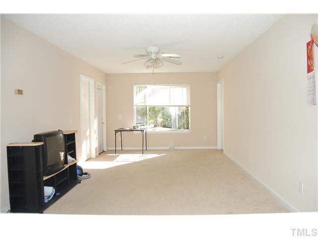 1500 Graduate Lane, Unit 104 Raleigh, NC 27606 - Photo 9 of 15 a living room with furniture and a flat screen tv