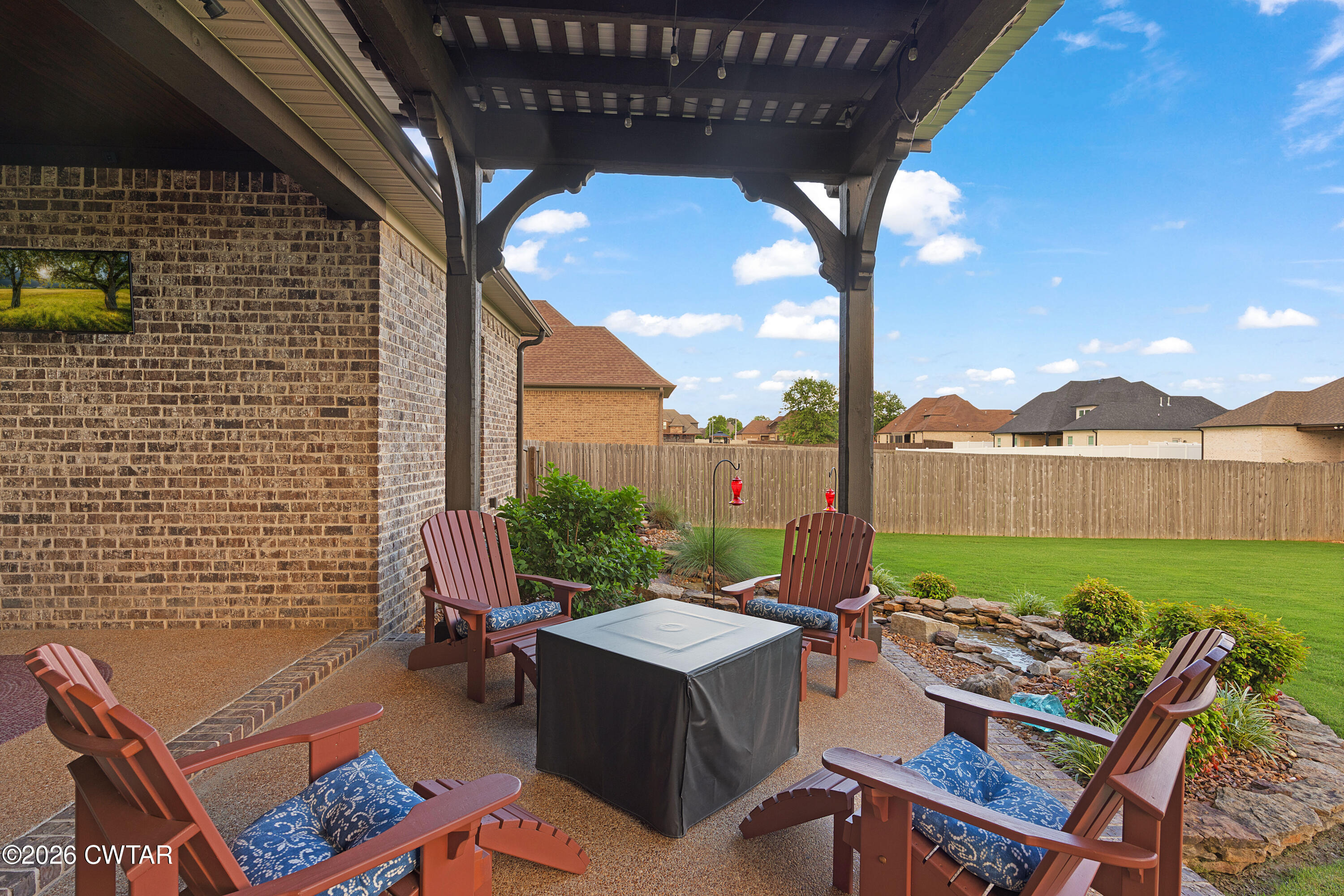 34 Cheddleton Cove Jackson, TN 38305 - Photo 26 of 32 a view of a patio with table and chairs and potted plants