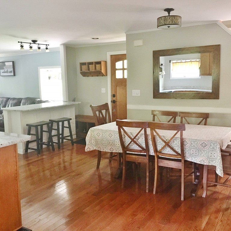 2 Stony Hill Road Holland, MA 01521 - Photo 7 of 24 a dining room with wooden floor a glass table and chairs