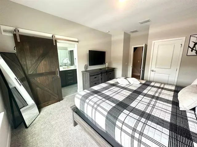 a bedroom with a bed and a television in it