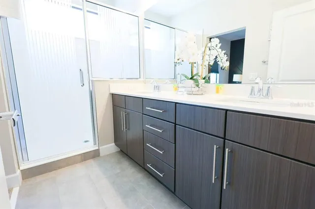 a bathroom with a double vanity sink and mirror