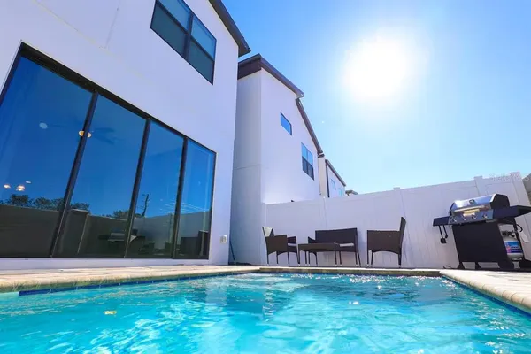 a view of a backyard with seating space