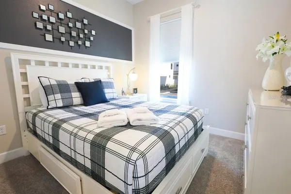 a bedroom with a bed and a window