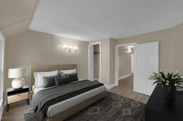 a bedroom with a bed and a potted plant