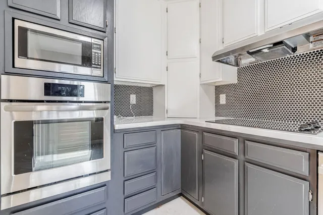 a kitchen with cabinets and steel stainless steel appliances