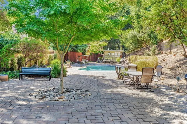 a view of a backyard with sitting area