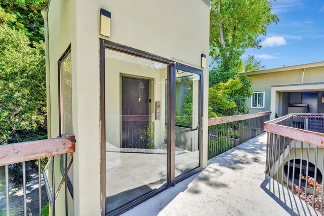 a view of balcony with furniture and garden