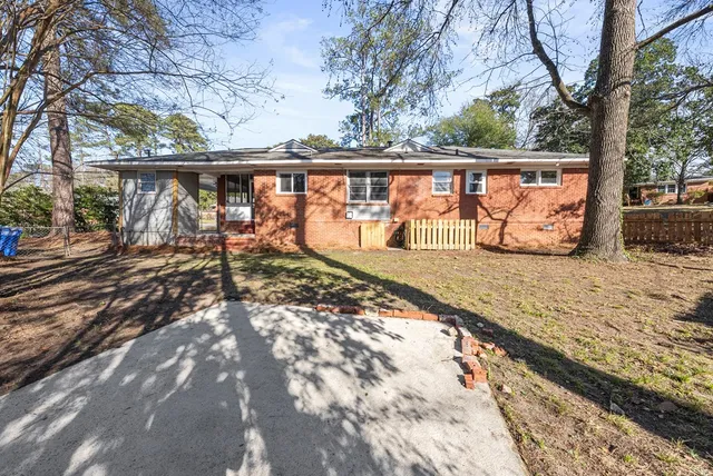 a view of a house with trees in the background