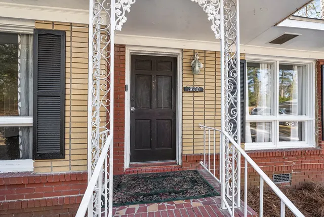 a view of front door of house with stairs