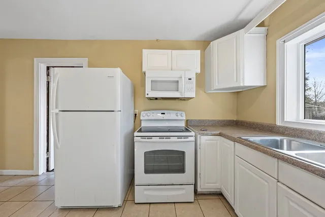 a kitchen with a stove top oven sink and refrigerator