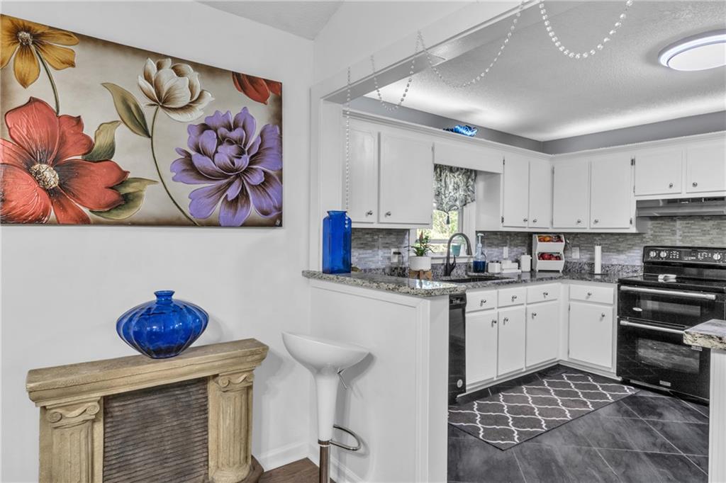 12 Ranger Road Southeast Cartersville, GA 30121 - Photo 12 of 51 a kitchen with stainless steel appliances granite countertop a sink a stove and cabinets