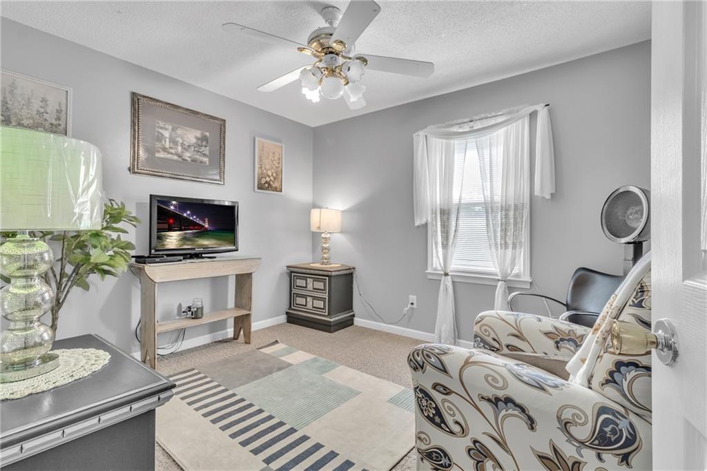 12 Ranger Road Southeast Cartersville, GA 30121 - Photo 18 of 51 a living room with furniture a fireplace and a flat screen tv