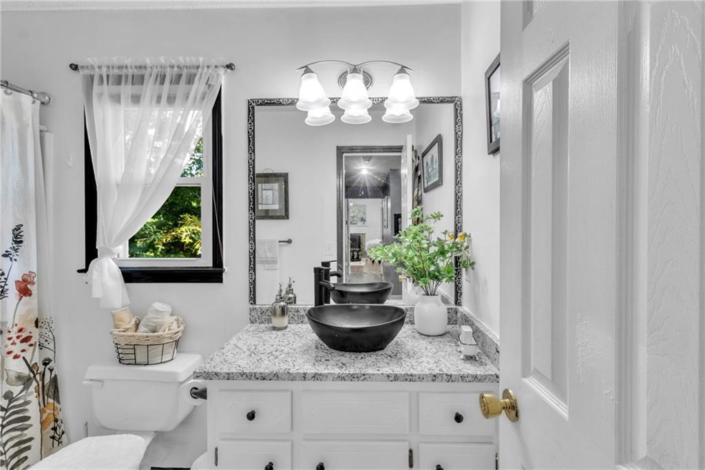 12 Ranger Road Southeast Cartersville, GA 30121 - Photo 20 of 51 a bathroom with a granite countertop sink a toilet and a mirror