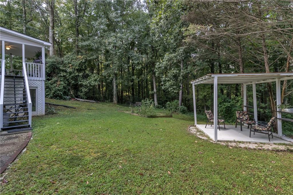 12 Ranger Road Southeast Cartersville, GA 30121 - Photo 34 of 51 a view of a chair and table in backyard of house