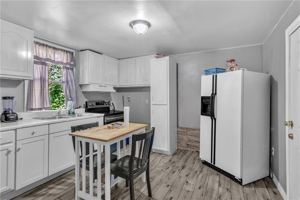 12 Ranger Road Southeast Cartersville, GA 30121 - Photo 39 of 51 a kitchen with stainless steel appliances a refrigerator a sink a stove a dining table and chairs