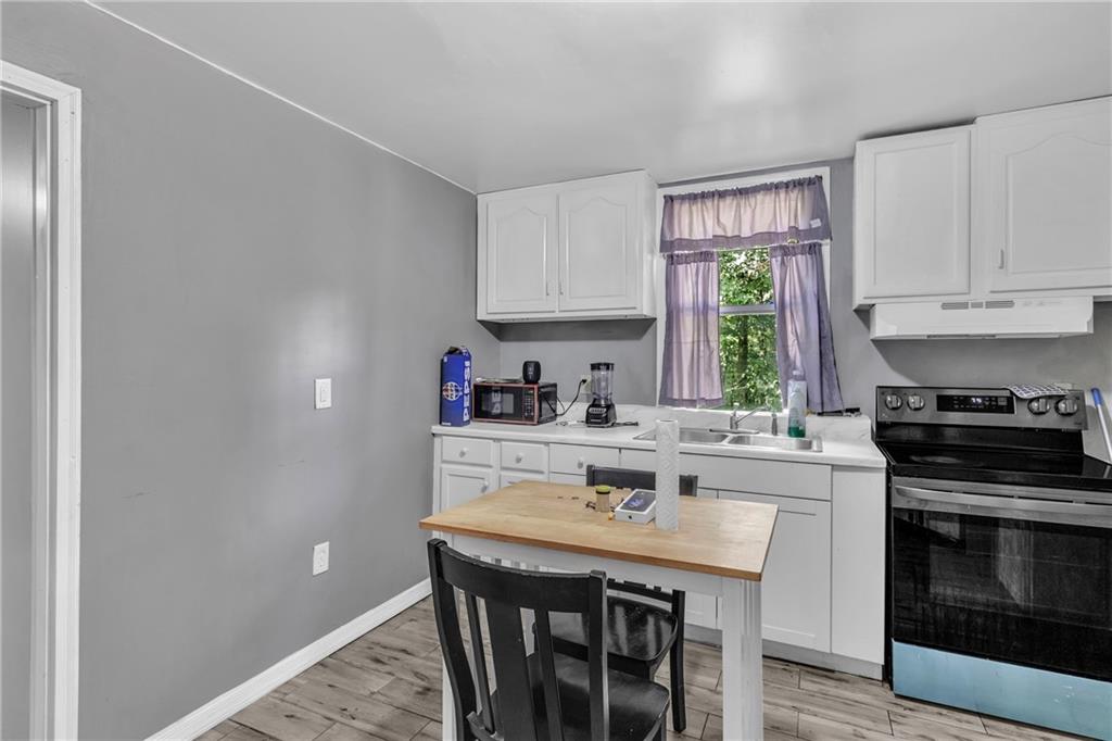 12 Ranger Road Southeast Cartersville, GA 30121 - Photo 41 of 51 a kitchen with stainless steel appliances granite countertop a stove a sink and a refrigerator