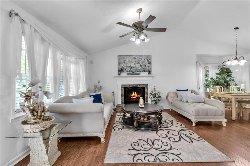 12 Ranger Road Southeast Cartersville, GA 30121 - Photo 8 of 51 a living room with furniture a chandelier and a fireplace