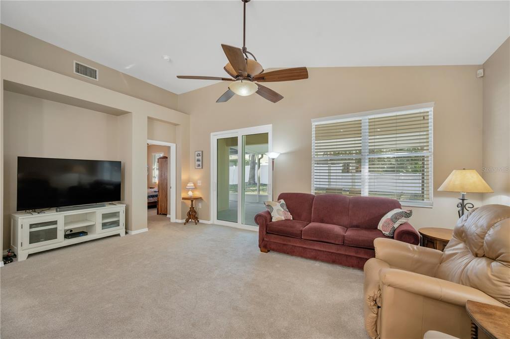 17115 Falconridge Road Lithia, FL 33547 - Photo 11 of 33 a living room with furniture and a flat screen tv