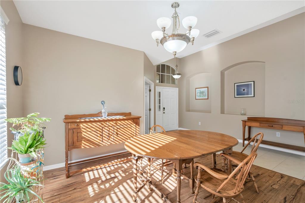 17115 Falconridge Road Lithia, FL 33547 - Photo 13 of 33 a view of a dining room with furniture and wooden floor