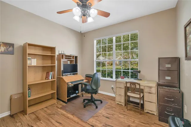 a view of a workspace with furniture and a window