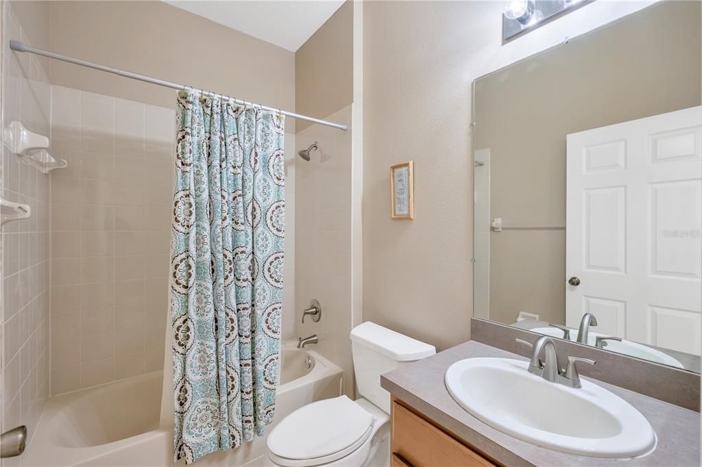 17115 Falconridge Road Lithia, FL 33547 - Photo 21 of 33 a bathroom with a sink toilet and shower